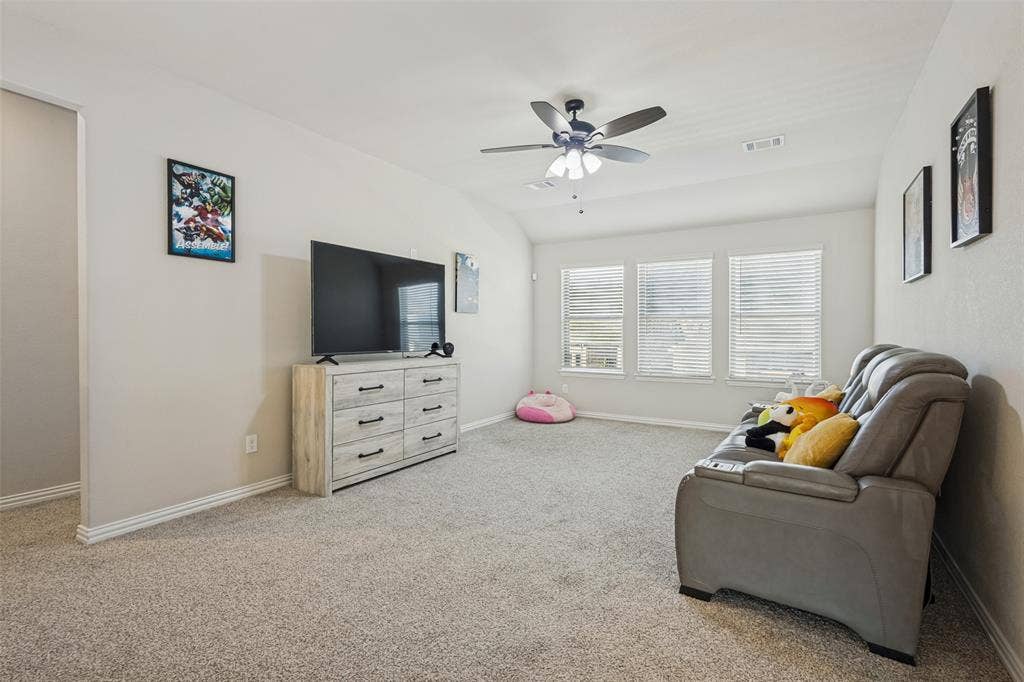 5313 Pratt Circle, McKinney, TX 75071 Vaulted ceilings featuring a ceiling fan with integrated lighting and three windows equipped with horizontal blinds