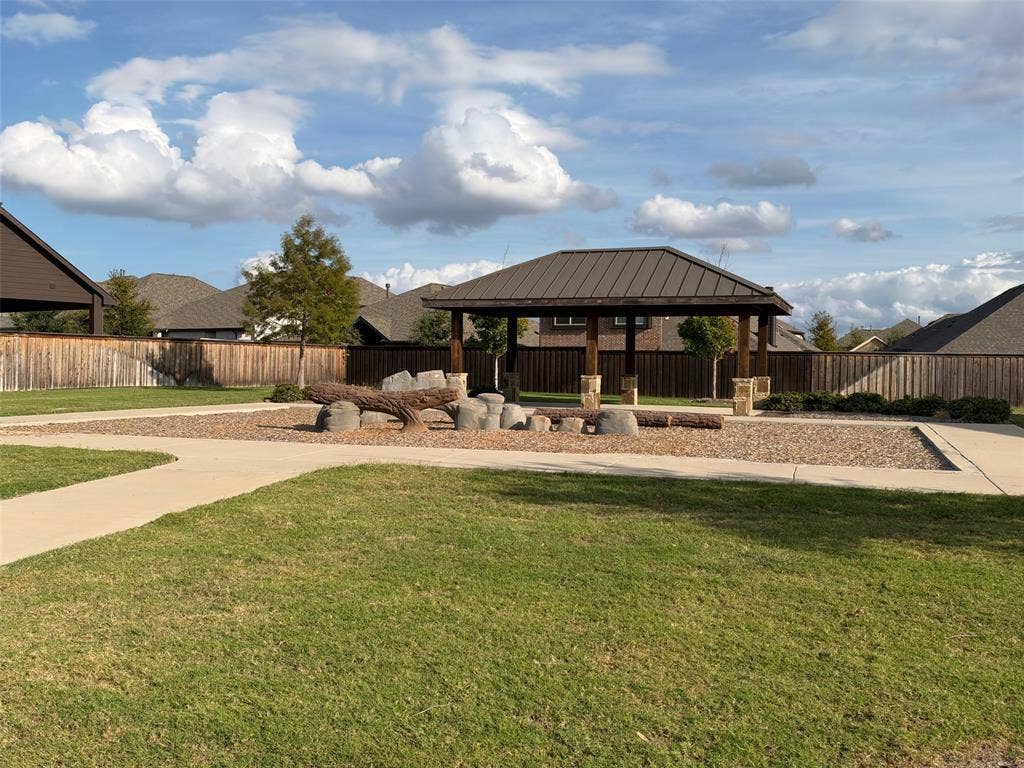 5313 Pratt Circle, McKinney, TX 75071 Covered pavilion with a metal roof and stone-based support pillars, concrete walkways, and natural stone hardscaping