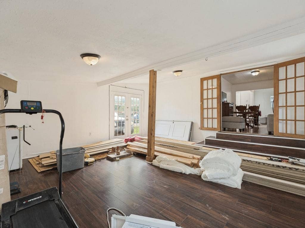 2009 Pecan Street, Commerce, TX 75428 Wood-finish flooring, exposed structural post, double-pane glass entry doors, and wood-framed French doors featuring multi-pane glass