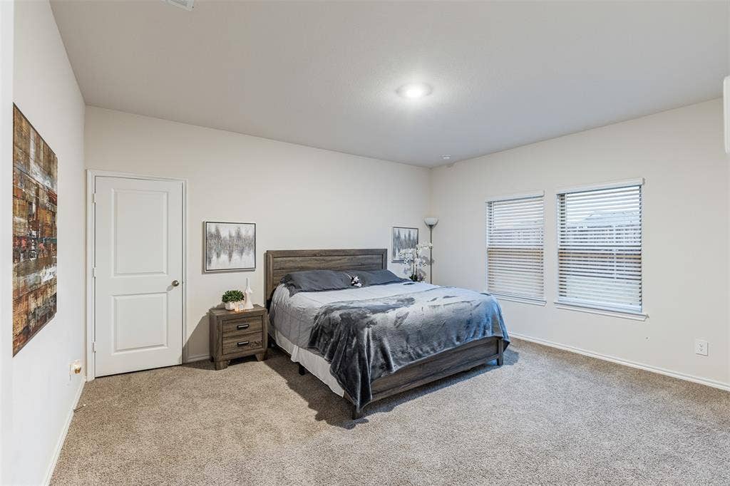 Neutral interior space featuring recessed lighting, carpeting, and two windows with horizontal blinds