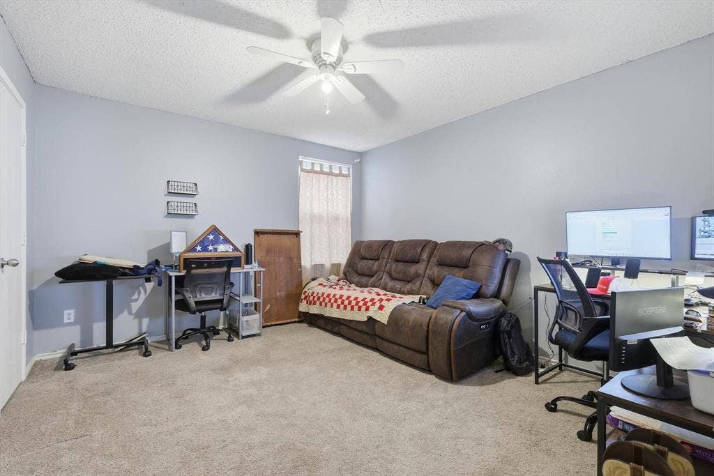 1633 Sierra Meadow Lane, Fort Worth, TX 76247 Neutral-toned interior space featuring wall-to-wall carpeting and a ceiling-mounted light fixture with a multi-blade fan