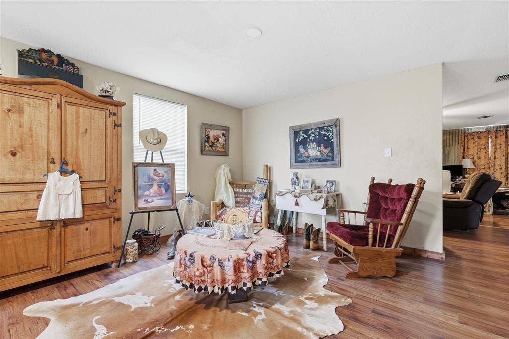 1633 Sierra Meadow Lane, Fort Worth, TX 76247 Wood-finish flooring throughout the space with neutral wall coloring