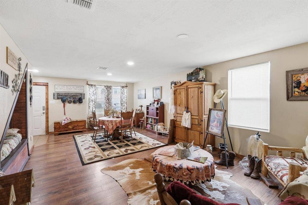 1633 Sierra Meadow Lane, Fort Worth, TX 76247 Open-concept interior featuring wood-finish flooring, recessed lighting, and windows with natural light