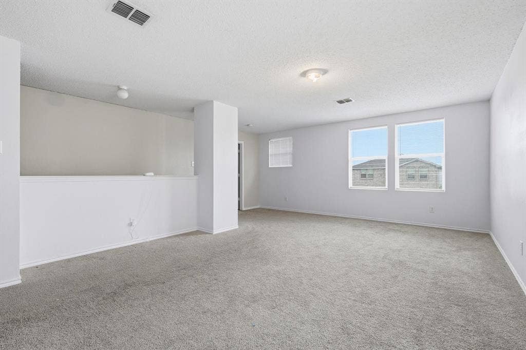1633 Sierra Meadow Lane, Fort Worth, TX 76247 Open-concept interior featuring neutral wall tones, wall-to-wall carpeting, and double-paned windows