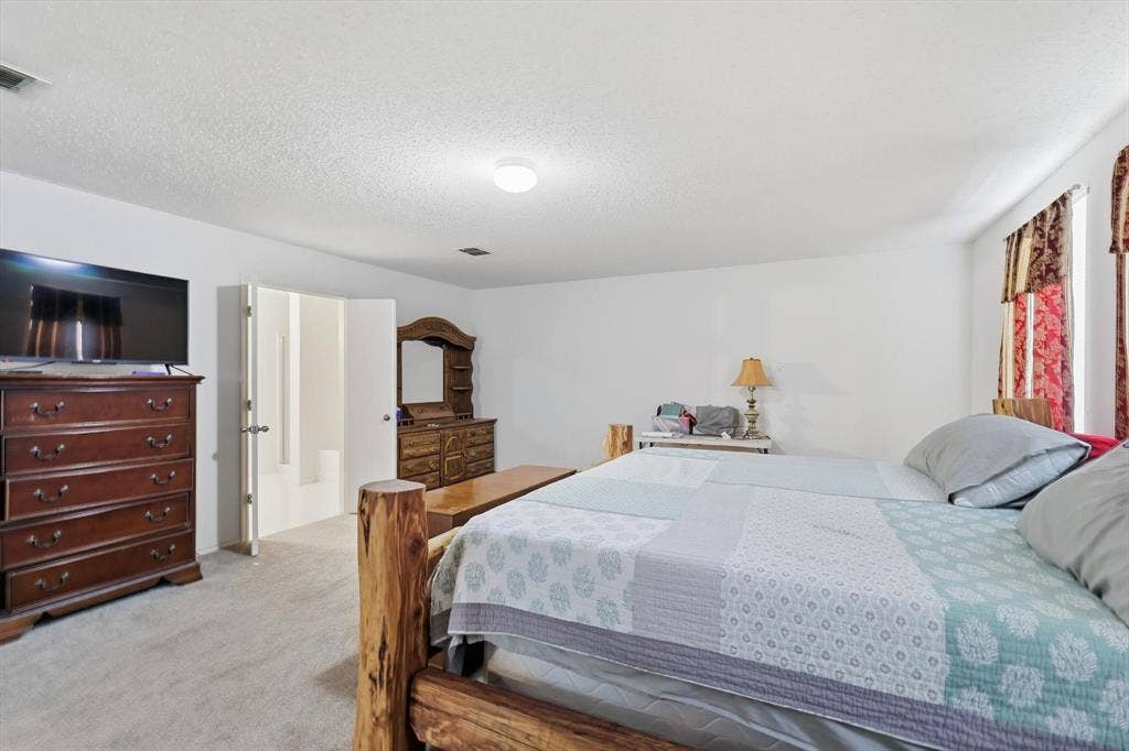 1633 Sierra Meadow Lane, Fort Worth, TX 76247 Neutral-toned carpet, textured ceiling, and double-door entry