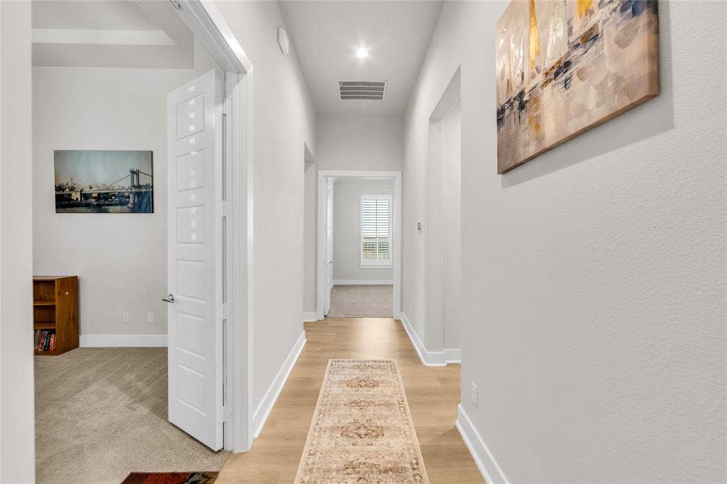 2971 Gaulding Drive, Prosper, TX 75078 Hallway featuring neutral wall tones, light wood-finish flooring, recessed lighting, and a multi-panel interior door