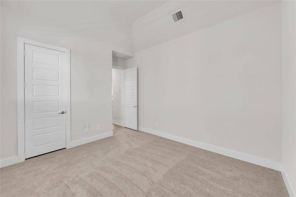 2971 Gaulding Drive, Prosper, TX 75078 Room featuring vaulted ceilings, neutral-toned carpeting, and five-panel interior doors with brushed nickel hardware