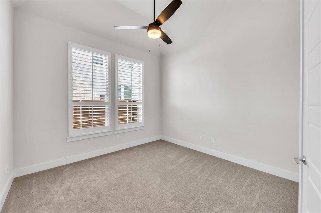 2971 Gaulding Drive, Prosper, TX 75078 Neutral interior featuring wall-to-wall carpeting, dual windows with plantation shutters, and a central ceiling fan