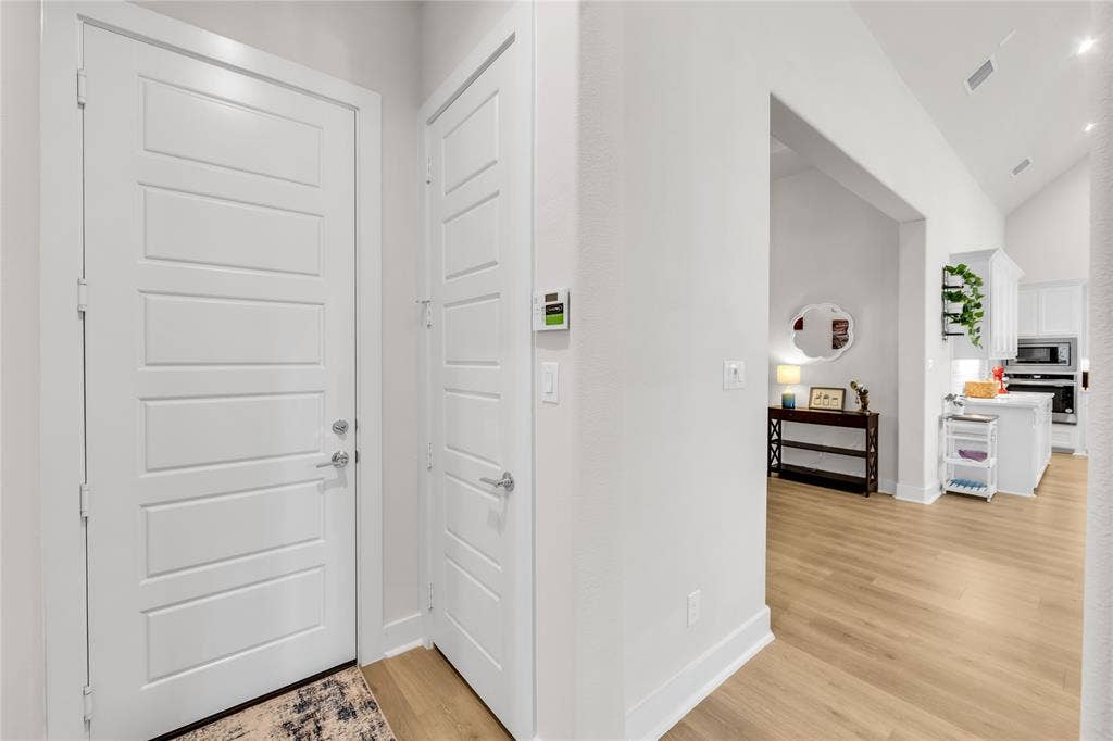 2971 Gaulding Drive, Prosper, TX 75078 Entryway featuring five-panel doors with satin nickel hardware, wood-finish flooring, and vaulted ceilings