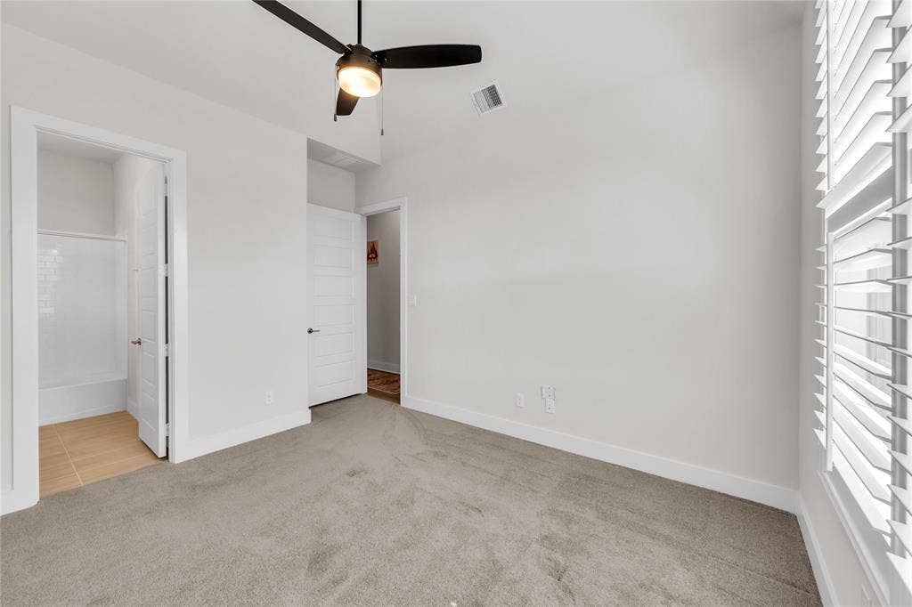2971 Gaulding Drive, Prosper, TX 75078 Room featuring neutral wall-to-wall carpeting, high ceilings with a central matte black ceiling fan, and plantation shutter window treatments