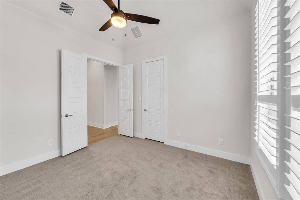 2971 Gaulding Drive, Prosper, TX 75078 Room featuring neutral carpeted flooring, white interior doors, plantation shutters, and a ceiling fan with integrated lighting