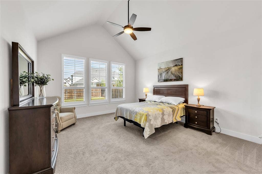 2971 Gaulding Drive, Prosper, TX 75078 Vaulted ceilings, carpeting, three panel windows with shutters, and a ceiling fan with integrated lighting
