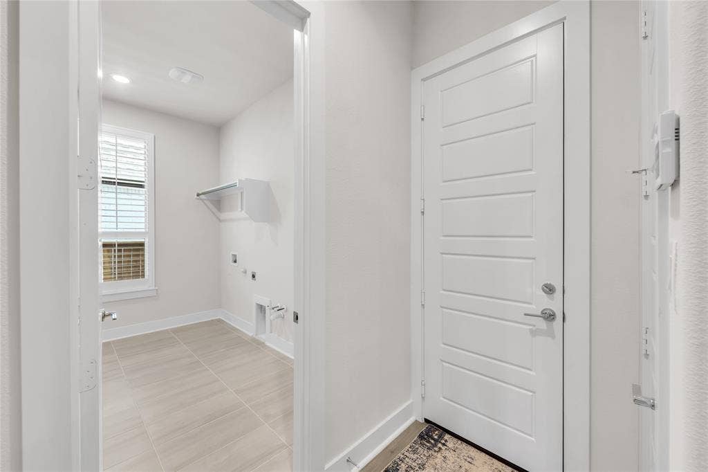 2971 Gaulding Drive, Prosper, TX 75078 Utility area featuring ceramic tile flooring, a wall-mounted shelving unit, and a window with shutter-style blinds
