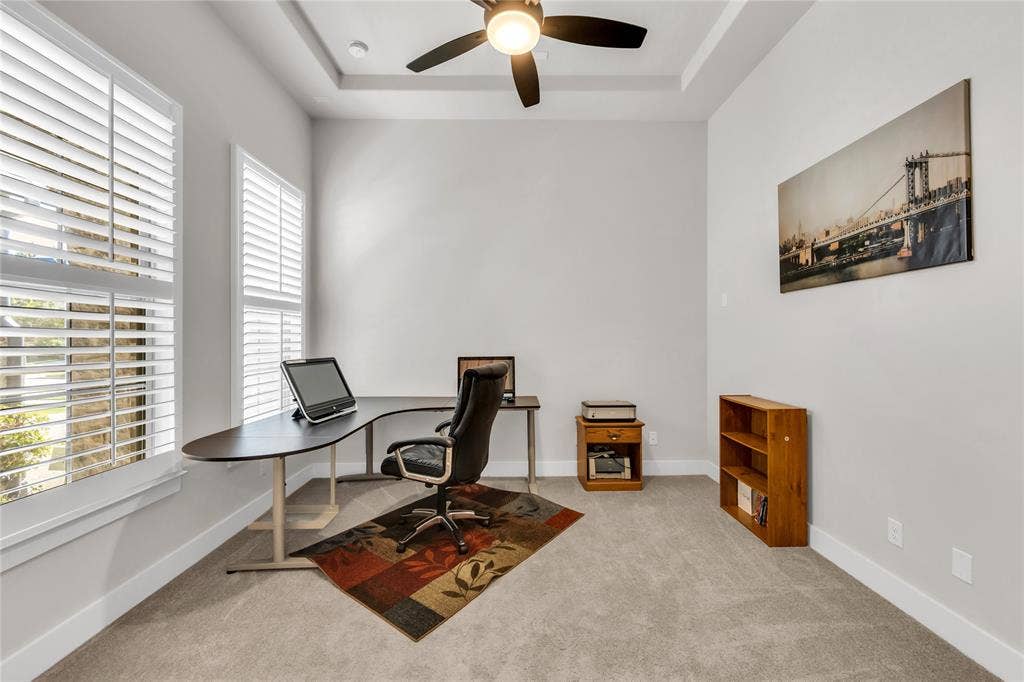 2971 Gaulding Drive, Prosper, TX 75078 Room featuring neutral carpeting, tray ceiling with a multi-blade ceiling fan, and windows outfitted with plantation shutters