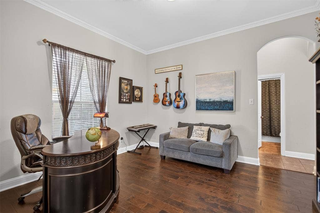 122 Anns Way, Forney, TX 75126 Room featuring wood-finish flooring, crown molding, and an arched entry
