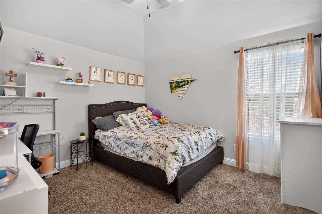 122 Anns Way, Forney, TX 75126 High ceilings with architectural volume, wall-mounted floating shelving, and carpeted flooring