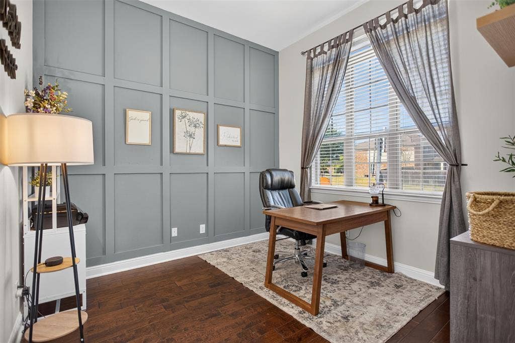122 Anns Way, Forney, TX 75126 Full-height wood paneling, dark-tone wood-finish flooring, and large window with blinds