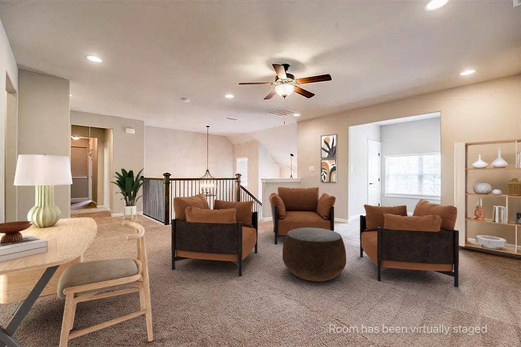336 Kaye Street, Coppell, TX 75019 Open floor plan featuring recessed lighting, a ceiling fan, wall-to-wall carpeting, and a staircase with a wooden handrail and metal balusters