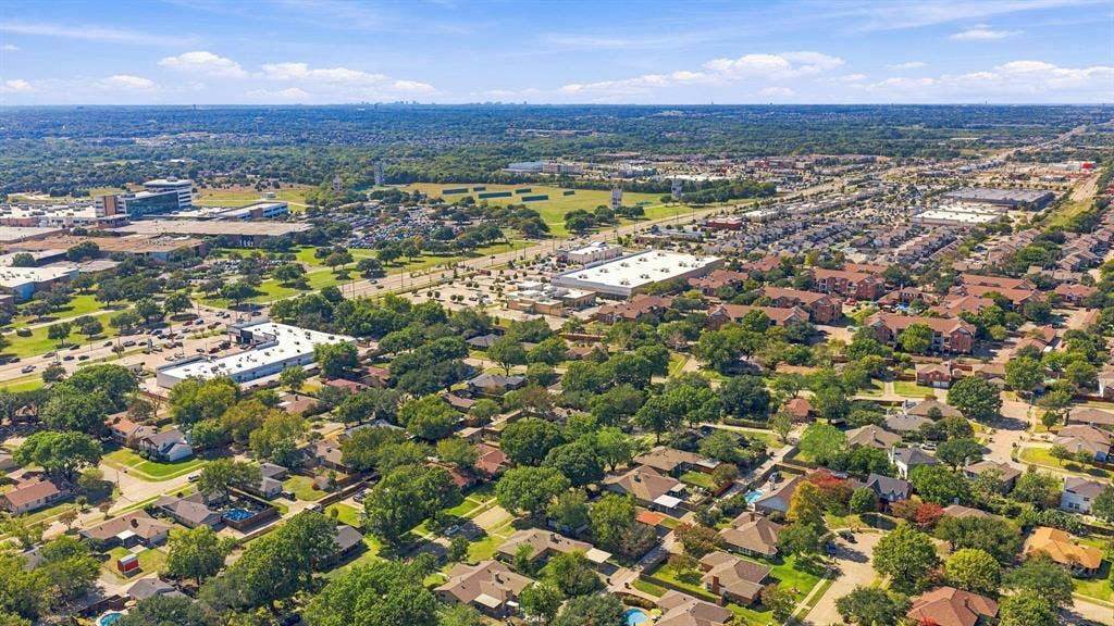 Aerial perspective featuring a residential landscape with mature trees and proximity to regional retail centers and thoroughfares