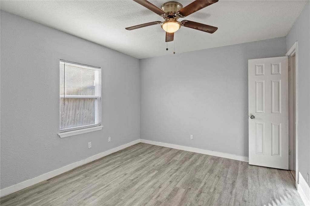 6543 Gentle River, Dallas, TX 75241 Neutral-toned interior featuring wood-finish flooring, a ceiling fan with integrated lighting