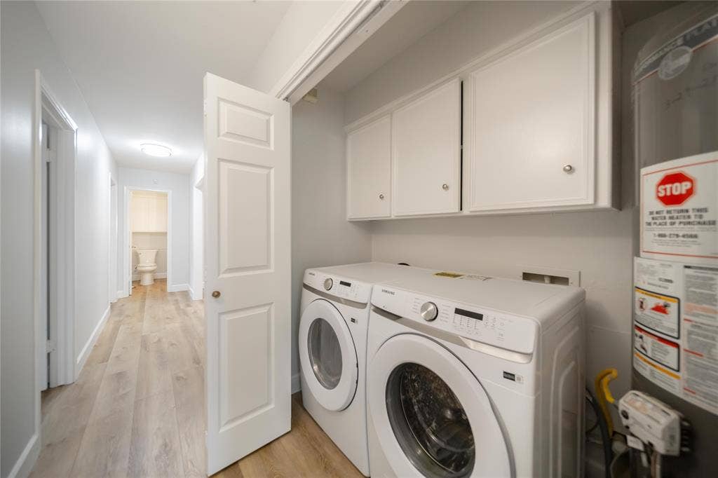 4333 Harvest Hill Road, Dallas, TX 75244 Laundry area featuring white shaker-style wall-mounted cabinetry, wood-finish flooring, and a six-panel interior door
