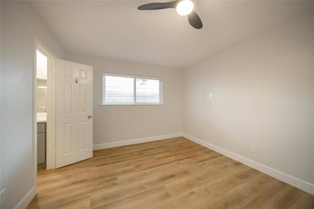 4333 Harvest Hill Road, Dallas, TX 75244 Room featuring wood-finish flooring, a neutral paint palette, a sliding window, and a three-blade ceiling fan with integrated lighting