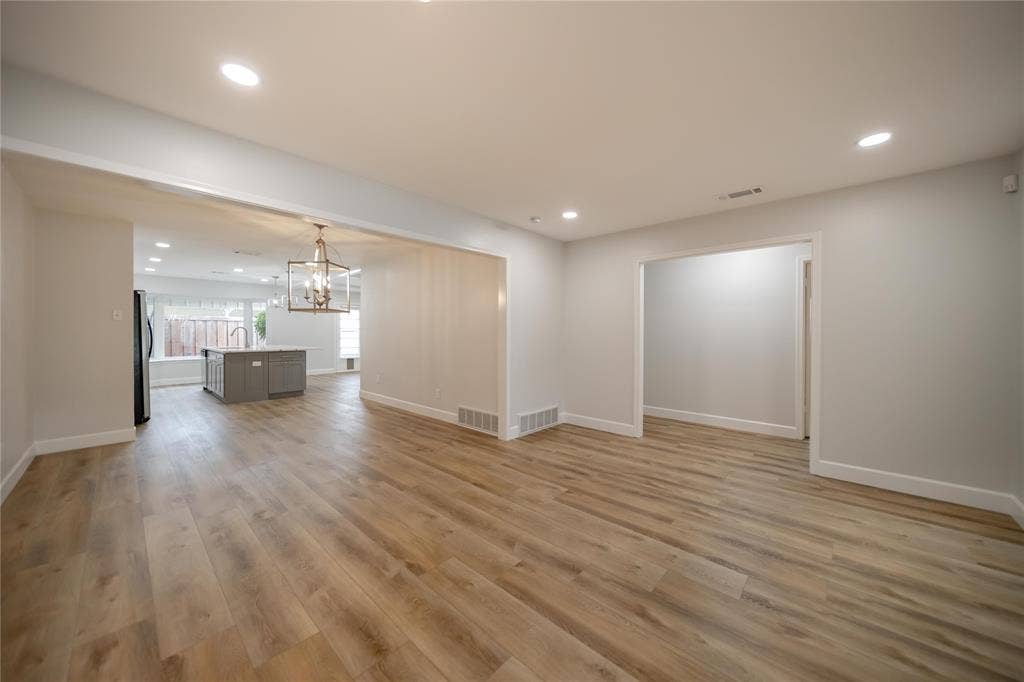 4333 Harvest Hill Road, Dallas, TX 75244 Open floor plan featuring wood-finish flooring, recessed lighting, and a metal lantern-style chandelier