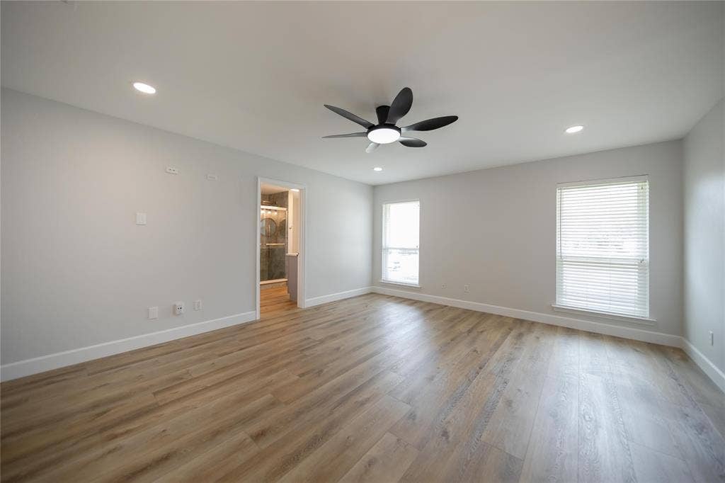4333 Harvest Hill Road, Dallas, TX 75244 Room featuring wood-finish flooring, recessed lighting, matte black ceiling fan with integrated lighting, and dual windows with horizontal blinds