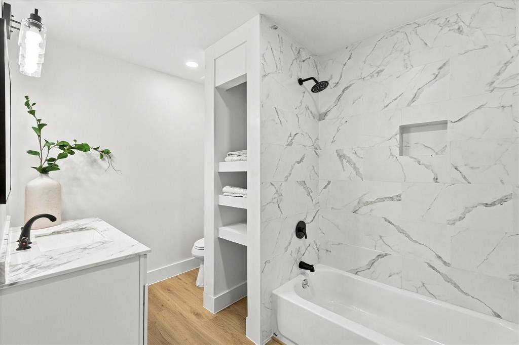 Remodeled secondary bathroom with linen closet.