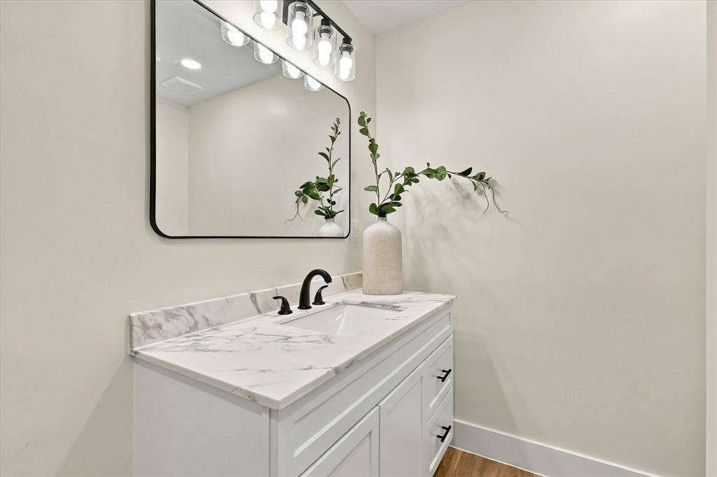 Secondary bath with brand new vanity and fixtures.