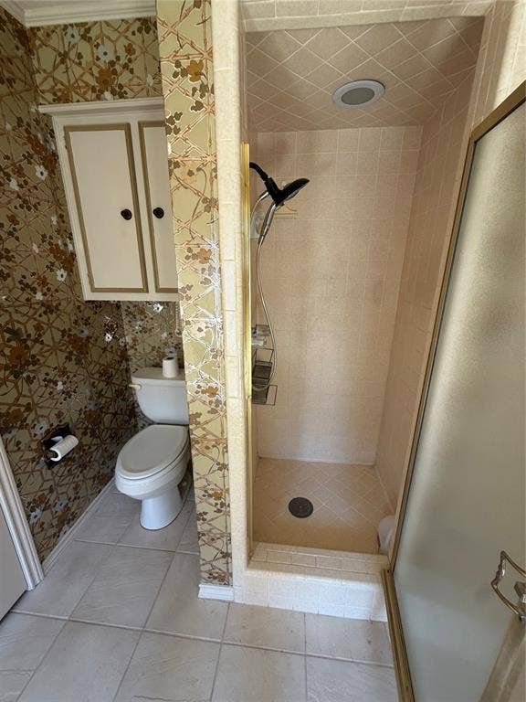 305 Westway Circle, Rockwall, TX 75087 Bathroom featuring a tiled stand-alone shower with a glass enclosure, wall-mounted cabinetry, and ceramic tile flooring