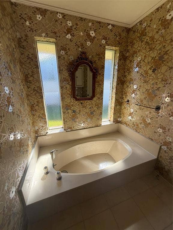 305 Westway Circle, Rockwall, TX 75087 Built-in soaking tub with a surrounding deck, two vertical privacy-glass windows, and a wall-mounted towel bar
