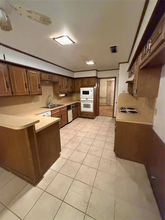 305 Westway Circle, Rockwall, TX 75087 Kitchen featuring wood cabinetry, tile flooring, built-in double wall oven, integrated cooktop, and peninsula counter space