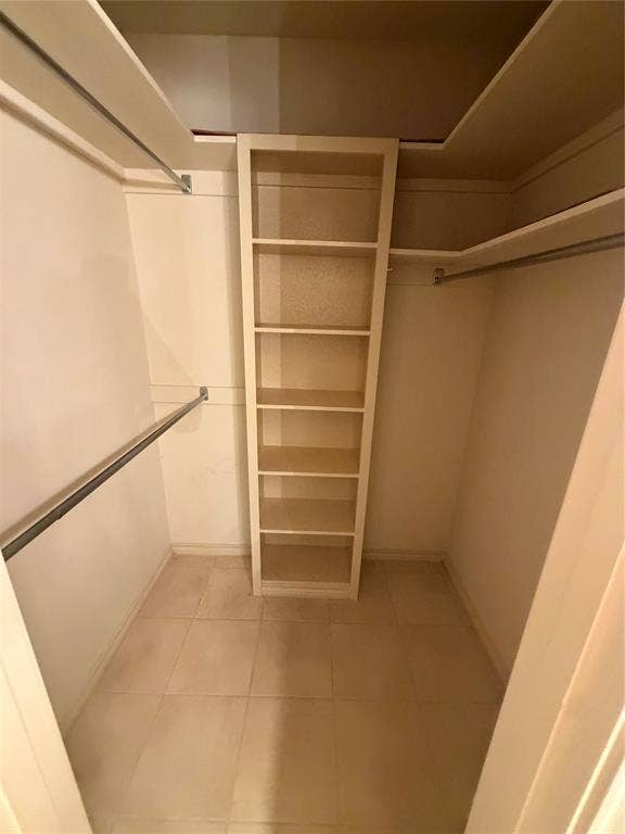 305 Westway Circle, Rockwall, TX 75087 Storage area featuring tile flooring, built-in shelving, and metal hanging rods