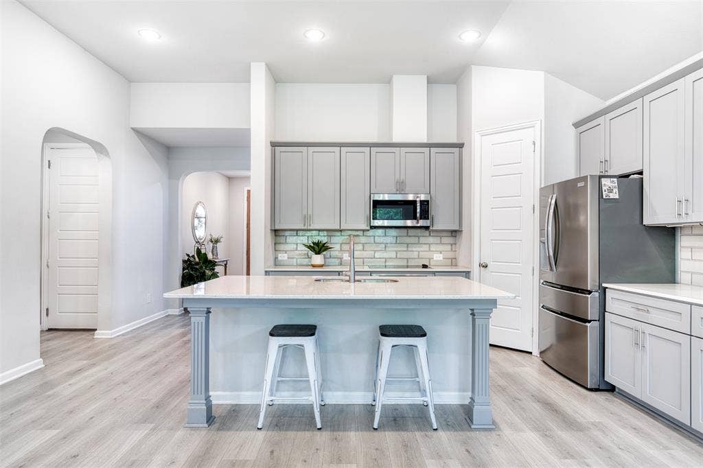 Kitchen with recessed lighting and oversized island.