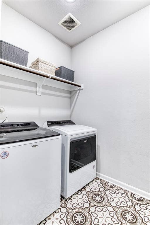 Laundry room with decorative tile flooring.