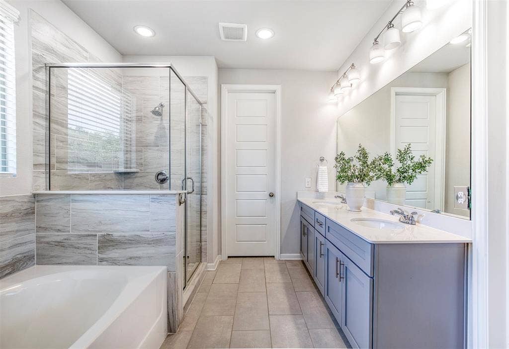 En-suite bath with dual sinks and walk-in closet.