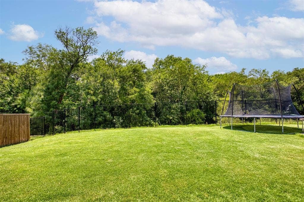 Backyard overlooks green space.