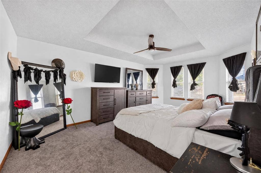 113 Dove Avenue, Red Oak, TX 75154 Tray ceiling featuring a central ceiling fan and multiple windows with exterior exposure