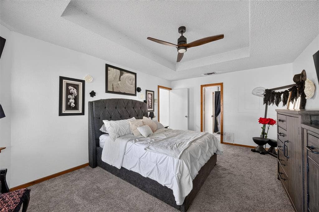 113 Dove Avenue, Red Oak, TX 75154 Tray ceiling featuring a dark-finish three-blade ceiling fan with integrated lighting