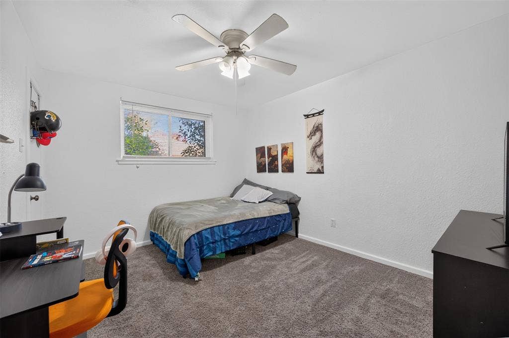 113 Dove Avenue, Red Oak, TX 75154 Room featuring neutral wall finishes, wall-to-wall carpeting, a multi-blade ceiling fan with integrated lighting, and a sliding window