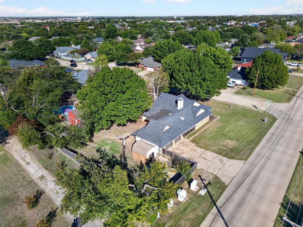 113 Dove Avenue, Red Oak, TX 75154 Aerial perspective of a multi-gabled roofline residence featuring an attached garage, paved driveway, detached storage structure, and expansive lot with mature tree canopy