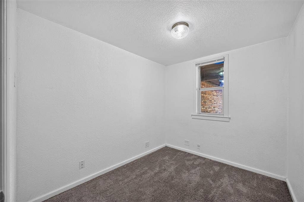 113 Dove Avenue, Red Oak, TX 75154 Neutral-toned carpeting and a single-hung window with a sill and white casing, accented by a centered flush-mount ceiling fixture