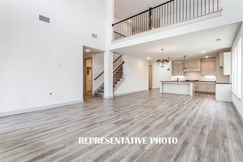 1405 Mistflower Lane, Celina, TX 75009 The family room is open to the game room upstairs creating multiple levels of open concept space for entertaining! REPRESENTATIVE PHOTO