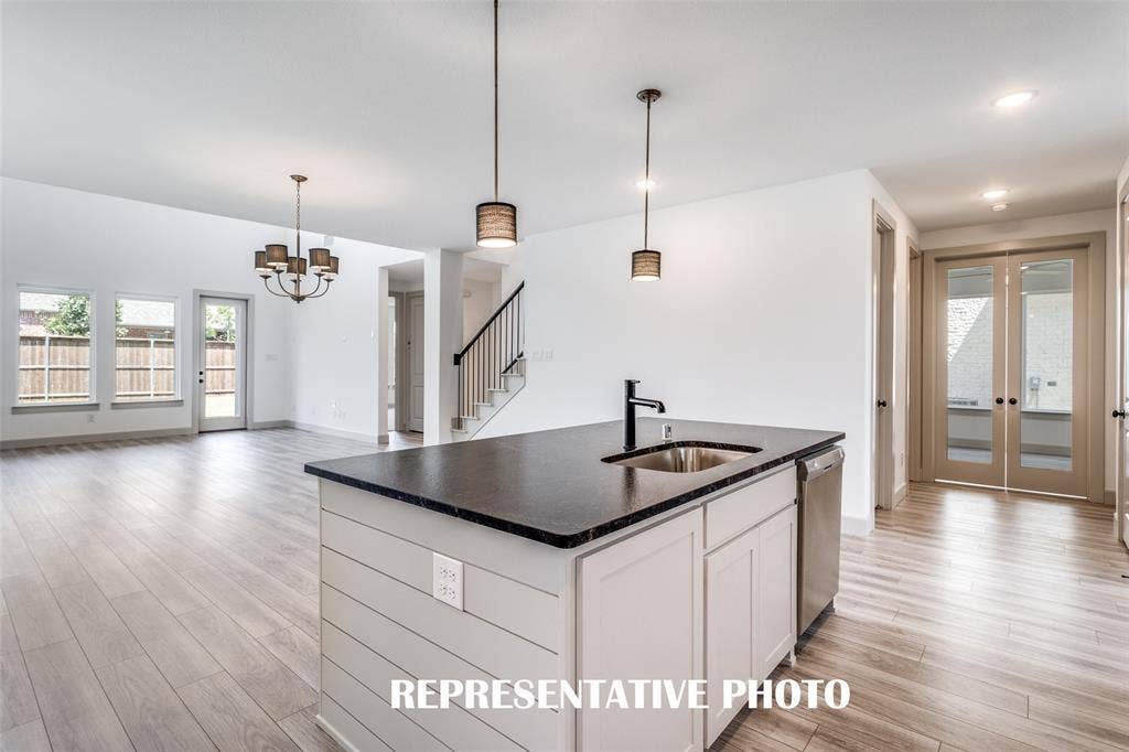 1405 Mistflower Lane, Celina, TX 75009 The large kitchen island is the perfect place for a quick family meal or after school homework station. REPRESENTATIVE PHOTO
