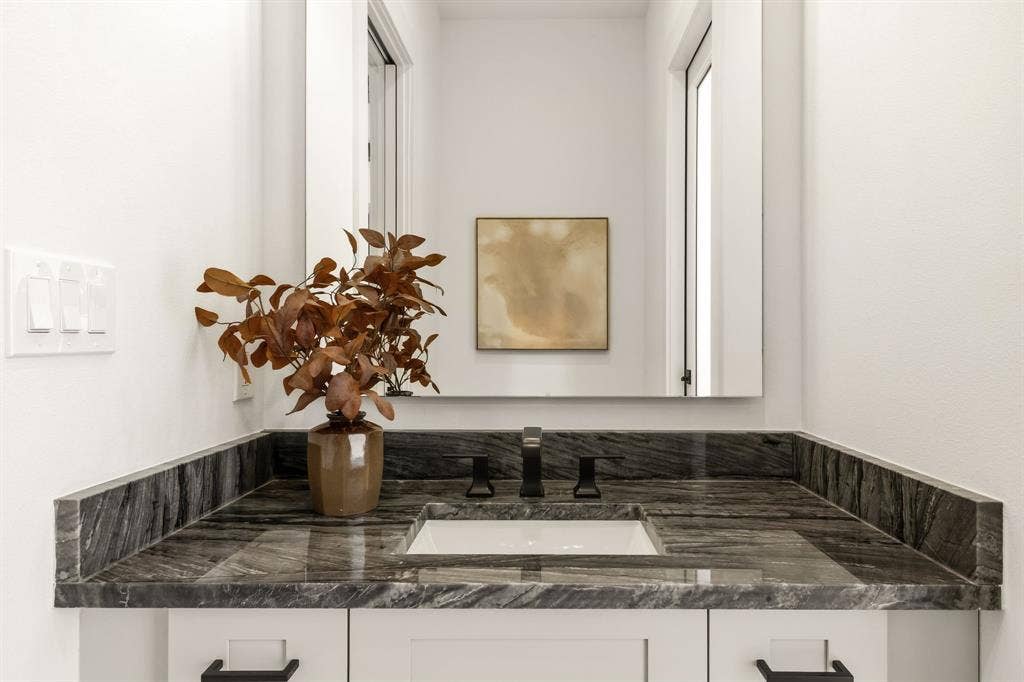 1217 Whisper Rock Drive, Rockwall, TX 75032 Powder bath directly off kitchen and accessible from back patio