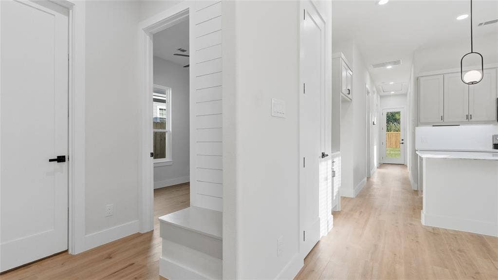 2816 Marburg Street, Dallas, TX 75215 Interior hallway featuring wood-finish flooring, shiplap wall detailing, built-in mudroom bench, recessed lighting, and modern pendant illumination