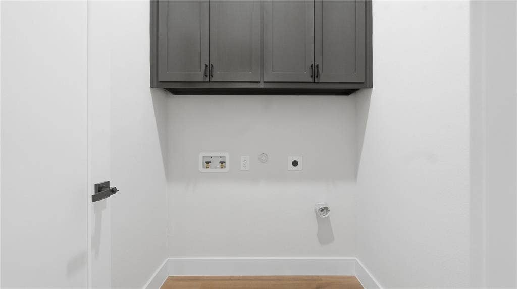 2816 Marburg Street, Dallas, TX 75215 Shaker-style wall cabinetry in a dark finish with matte black hardware, paired with wood-finish flooring