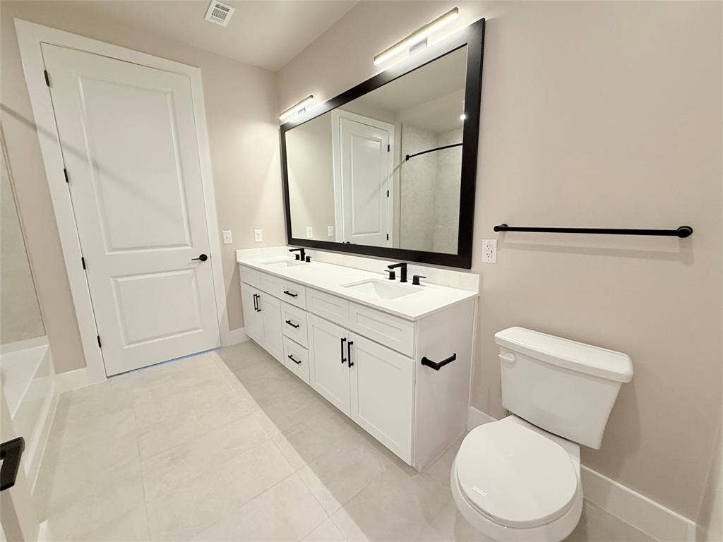 3255 Carlisle Street, #1207, Dallas, TX 75204 Bathroom with double vanity and light tile patterned flooring