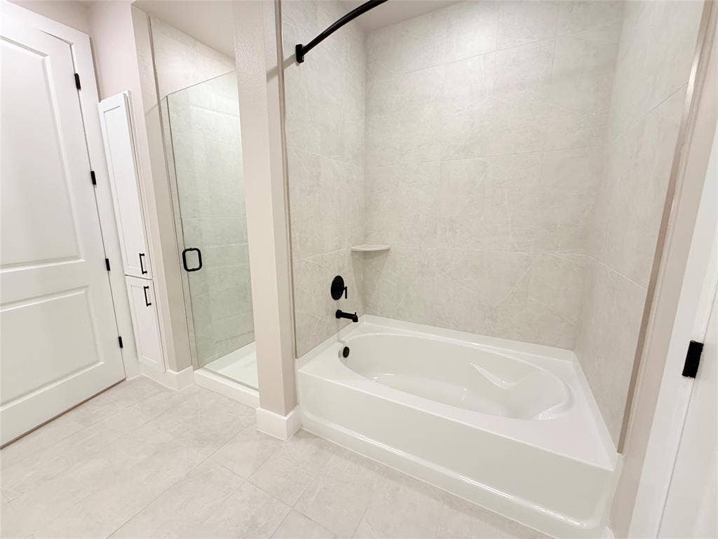 3255 Carlisle Street, #1207, Dallas, TX 75204 Full bath with a garden tub, a stall shower, and tile patterned flooring